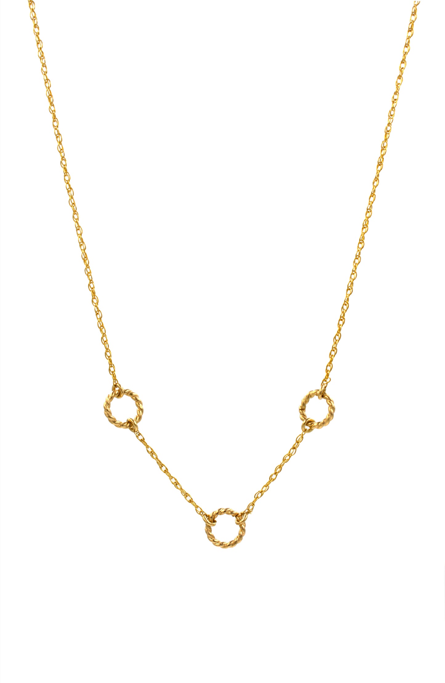Gold necklace with small circular pendants on a white background
