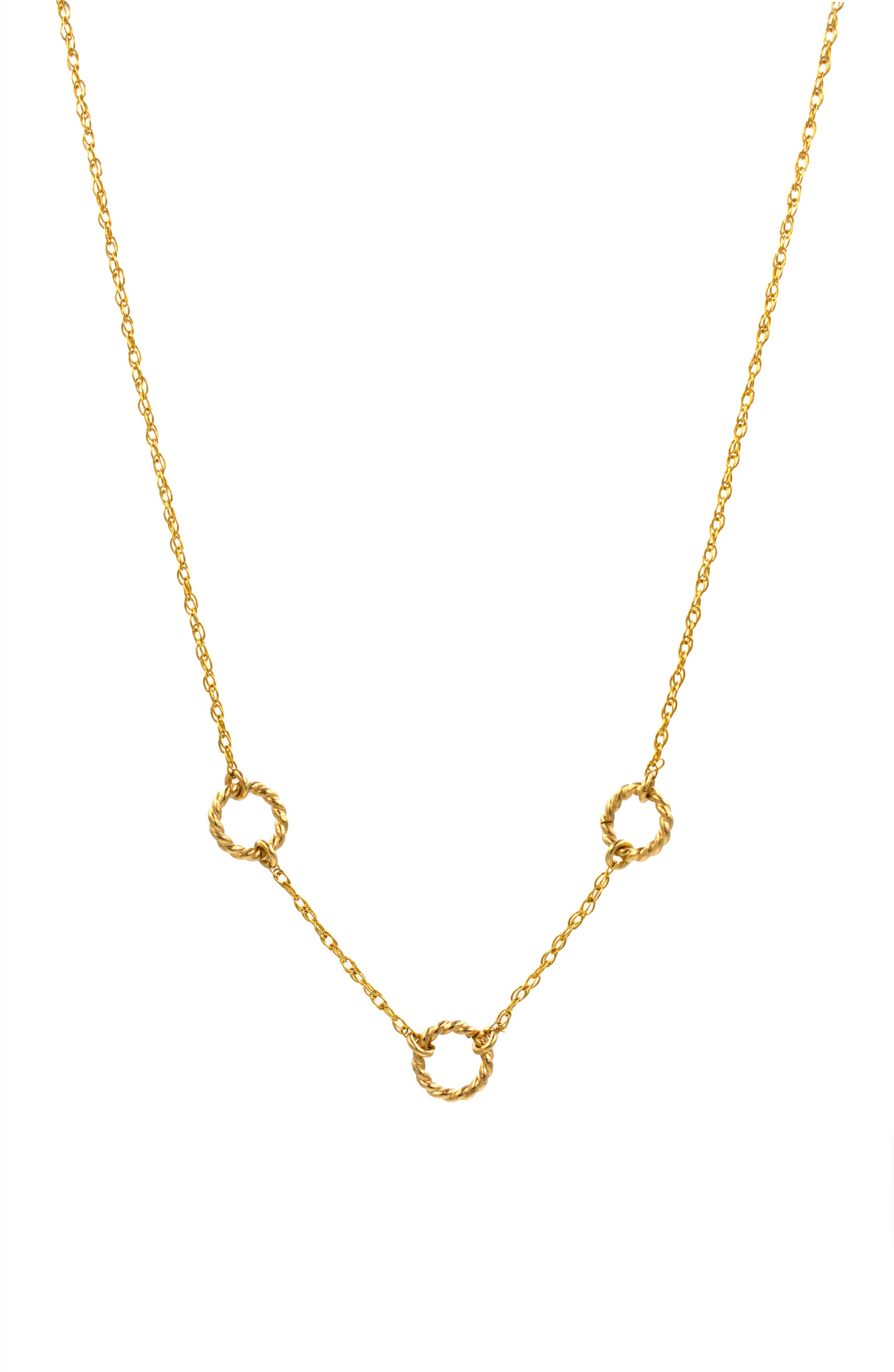 Gold necklace with small circular pendants on a white background