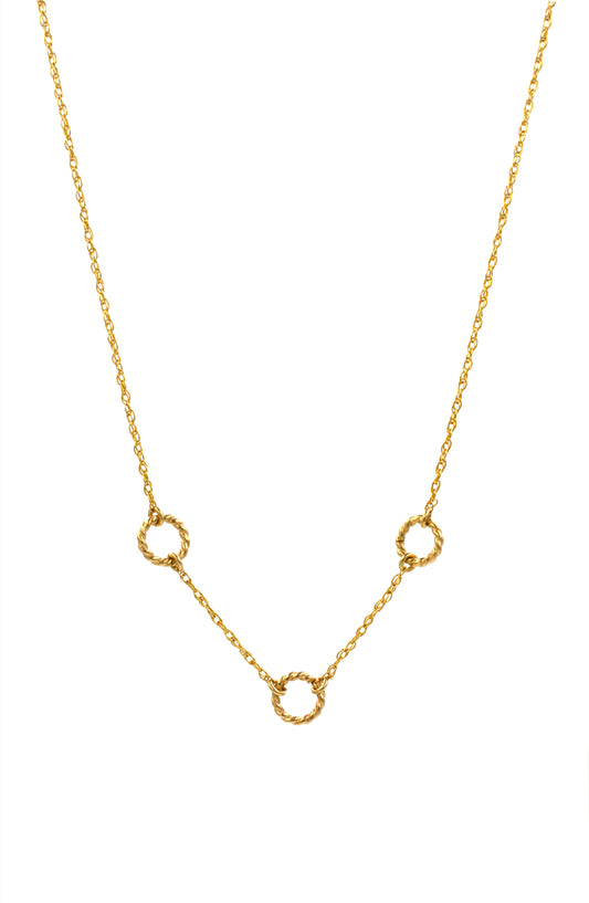 Gold necklace with small circular pendants on a white background