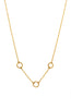 Gold necklace with small circular pendants on a white background